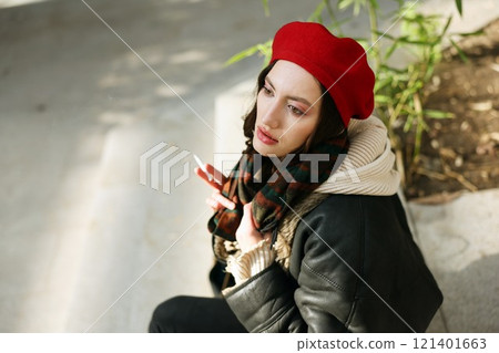 Chic and Stylish Young Woman Wearing a Red Beret with Leather Jacket in Urban Setting Chic and Stylish Young Woman Wearing a Red Beret with Leather Jacket in Urban Setting 121401663
