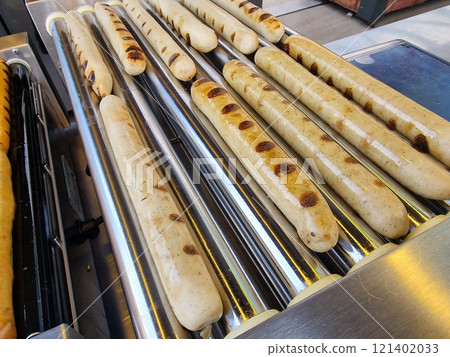 Sausage cooking on rolling bars Sausage cooking on rolling bars 121402033
