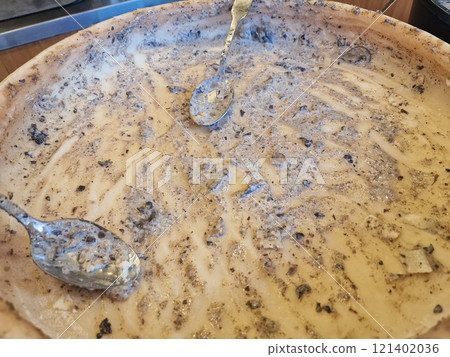 parmesan cheese cooking inside the wheel 121402036
