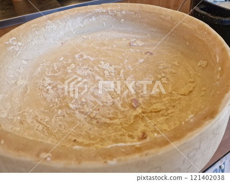 parmesan cheese cooking inside the wheel parmesan cheese cooking inside the wheel 121402038