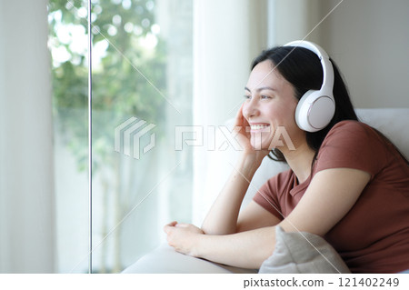 Happy asian woman wearing headphone listening audio relaxing 121402249
