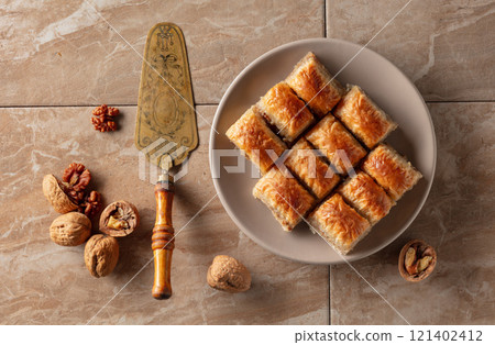 Baklava with walnuts on a beige plate. Baklava with walnuts on a beige plate. 121402412