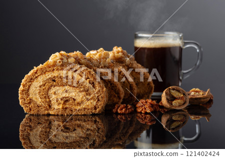 Dessert with walnuts and coffee on a black reflective background. Dessert with walnuts and coffee on a black reflective background. 121402424