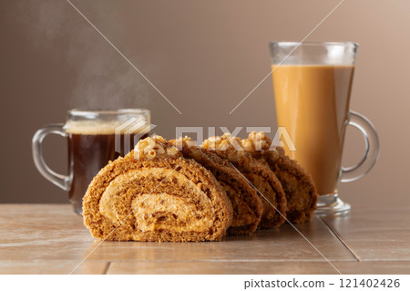 Dessert with walnuts and coffee on a beige background. Dessert with walnuts and coffee on a beige background. 121402426