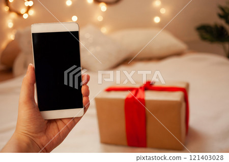 Online shopping for Christmas. New Year's gifts with home delivery. Phone, credit card New Year 2021 in the face of pandemic and coronavirus. Online shopping for Christmas. New Year's gifts with home delivery. Phone, credit card New Year 2021 in the face of pandemic and coronavirus. 121403028