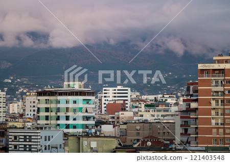 blocks and mountains at dusk in the city of Tirana, Albania blocks and mountains at dusk in the city of Tirana, Albania 121403548