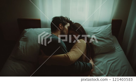 Young couple embracing tenderly in bed, sharing intimate moment Young couple embracing tenderly in bed, sharing intimate moment 121403583