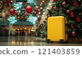 Yellow suitcase standing next to christmas tree in shopping mall 121403859