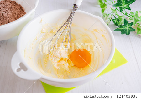 Add egg yolk to room temperature margarine with butter 121403933