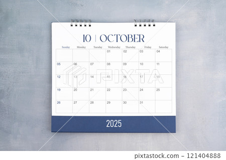 October 2025 desk calendar on gray cement wall background. Page of annual monthly calendar for plan. 121404888