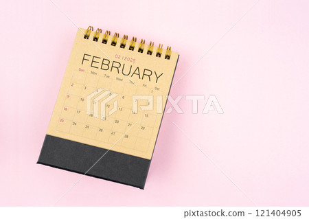 Brown calendar for February 2025 on pink background. Planning concept. 121404905