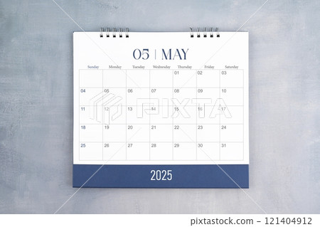 May 2025 desk calendar on gray cement wall background. Page of annual monthly calendar for plan. 121404912