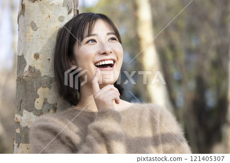 A woman walking through the forest A woman walking through the forest 121405307