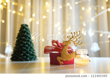 gift box with Christmas tree and Christmas scenic decor on table and colorful light bokeh background gift box with Christmas tree and Christmas scenic decor on table and colorful light bokeh background 121405395