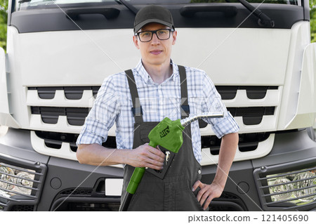 Man with biofuel filling nozzle on a background of truck Man with biofuel filling nozzle on a background of truck 121405690