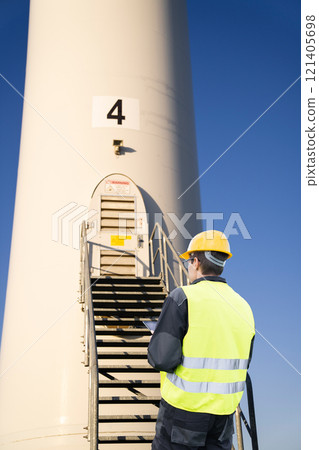 Engineer with tablet computer on a background of wind turbine 121405698