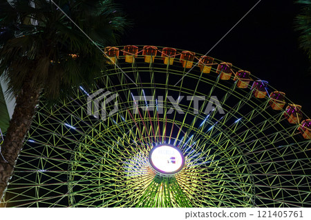 Ferris wheel. Noria. Christmas lights in Vigo, Pontevedra. Christmas decorations. Tourists strolling through its streets. Ferris wheel in the dark showing neon colors. VIGO. SPAIN. 23 December 2024. Ferris wheel. Noria. Christmas lights in Vigo, Pontevedra. Christmas decorations. Tourists strolling through its streets. Ferris wheel in the dark showing neon colors. VIGO. SPAIN. 23 December 2024. 121405761