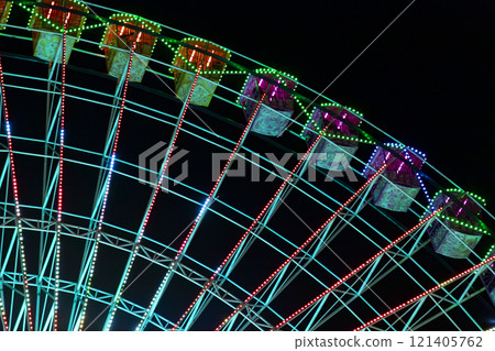 Ferris wheel. Noria. Christmas lights in Vigo, Pontevedra. Christmas decorations. Tourists strolling through its streets. Ferris wheel in the dark showing neon colors. VIGO. SPAIN. 23 December 2024. Ferris wheel. Noria. Christmas lights in Vigo, Pontevedra. Christmas decorations. Tourists strolling through its streets. Ferris wheel in the dark showing neon colors. VIGO. SPAIN. 23 December 2024. 121405762