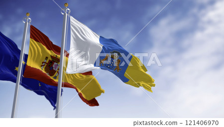 Canary Islands , spanish and EU flag waving in the wind Canary Islands , spanish and EU flag waving in the wind 121406970