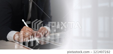 Businessperson using a digital pen on a tablet with financial graphs and data overlay, representing market analysis and financial investment growth. 121407282