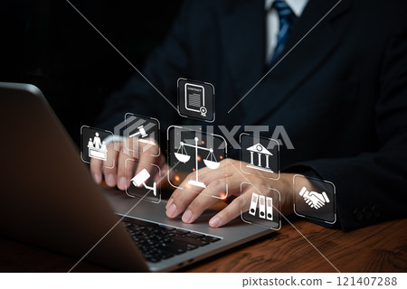 Hand holding holographic icons representing justice, law, and governance tools. Highlights legal systems, compliance, and balance of power. 121407288