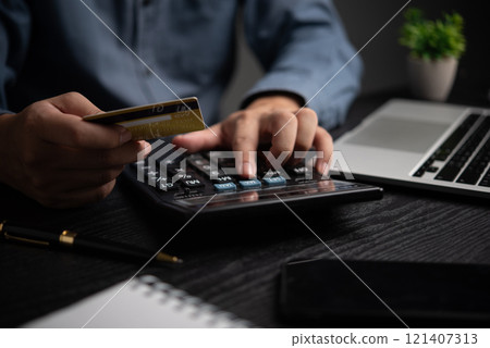 Businessman using calculator bookkeeping payroll and budget tax. Business document finance accounting investment 121407313