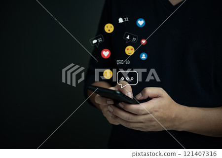 Person holding a smartphone with social media icons floating, representing digital engagement, communication, and social interaction. Person holding a smartphone with social media icons floating, representing digital engagement, communication, and social interaction. 121407316