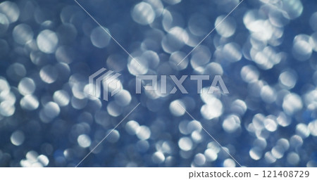Defocused spectrum. Blinking glitter. Decorative festive background with gray chaotic circles. Flickering silver rays delicate atmosphere. 121408729