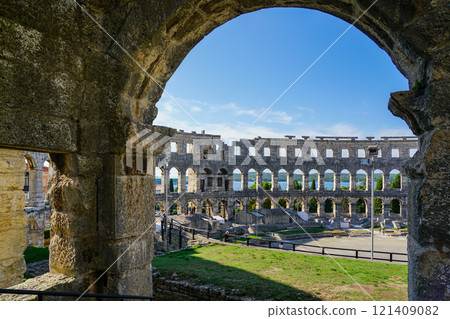 Facade of the ancient ruins of one of the largest preserved Roman amphitheaters in Pula, Istria 121409082