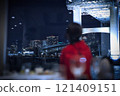 A woman looking up at an illuminated bridge 121409151