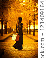 Foreign woman reading in autumn park 121409164