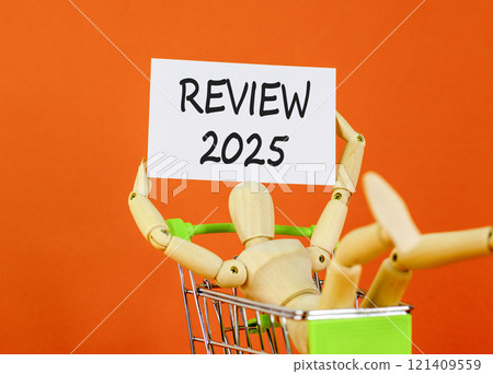 Planning review 2025 new year symbol. Concept words Review 2025 on beautiful white paper on wooden clothespin. Beautiful orange background. Business review 2025 new year concept. Copy space. 121409559