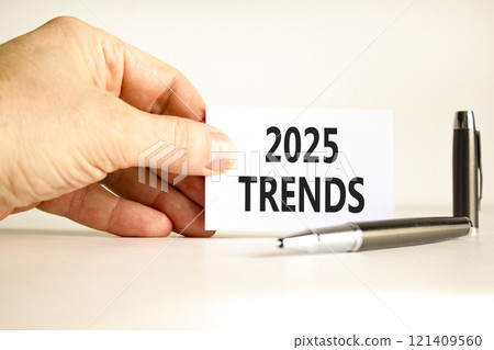 Planning 2025 trends new year symbol. Concept words 2025 Trends on beautiful white card. Beautiful white background. Businessman hand. Business 2025 trends new year concept. Copy space. Planning 2025 trends new year symbol. Concept words 2025 Trends on beautiful white card. Beautiful white background. Businessman hand. Business 2025 trends new year concept. Copy space. 121409560