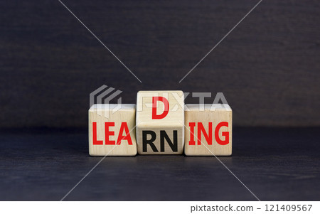 Learning or leading symbol. Concept words Learning Leading on wooden block. Beautiful black table black background. Business learning or leading concept. Copy space. Learning or leading symbol. Concept words Learning Leading on wooden block. Beautiful black table black background. Business learning or leading concept. Copy space. 121409567