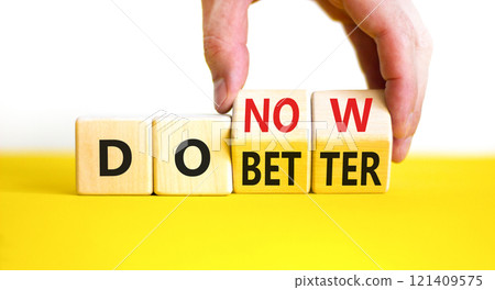 Do better and now symbol. Concept words Do better Do now on wooden block. Beautiful yellow table white background. Businessman hand. Business do better and now concept. Copy space. Do better and now symbol. Concept words Do better Do now on wooden block. Beautiful yellow table white background. Businessman hand. Business do better and now concept. Copy space. 121409575