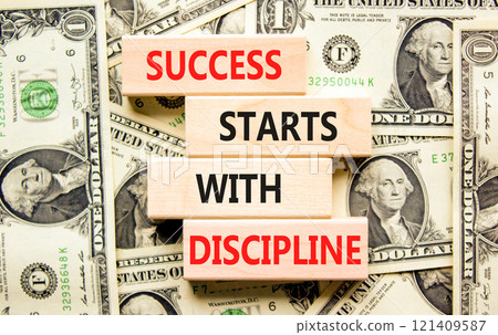 Success starts with discipline symbol. Concept words Success starts with discipline on beautiful wooden blocks. Beautiful dollar background. Business success starts with discipline concept. Copy space Success starts with discipline symbol. Concept words Success starts with discipline on beautiful wooden blocks. Beautiful dollar background. Business success starts with discipline concept. Copy space 121409587