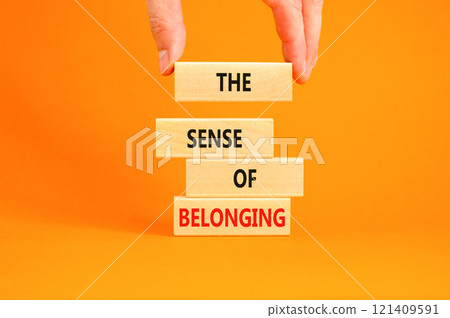 The sense of belonging symbol. Concept words The sense of belonging on beautiful wooden blocks. Beautiful orange table orange background. Business and the sense of belonging concept. Copy space. 121409591
