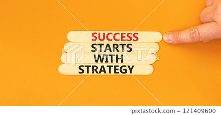 Success starts with strategy symbol. Concept words Success starts with strategy on beautiful wooden sticks. Beautiful orange background. Business and success starts with strategy concept. Copy space. 121409600