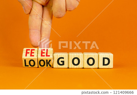 Look and feel good symbol. Concept words Look good Feel good on wooden cubes. Beautiful orange table orange background. Doctor hand. Healthy lifestyle look and feel good concept. Copy space. 121409666