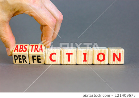 Perfection or abstraction symbol. Concept words Perfection Abstraction on beautiful wooden blocks. Beautiful grey background. Businessman hand. Business perfection or abstraction concept. Copy space Perfection or abstraction symbol. Concept words Perfection Abstraction on beautiful wooden blocks. Beautiful grey background. Businessman hand. Business perfection or abstraction concept. Copy space 121409673