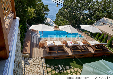 Courtyard with swimming pool and beach umbrellas. Elevated view. 121409717
