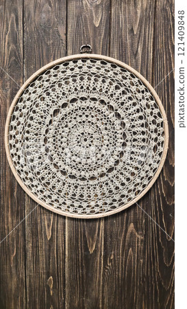 Crochet napkin on a wooden frame. Mandala with different patterns Decor Handmade Crochet napkin on a wooden frame. Mandala with different patterns Decor Handmade 121409848