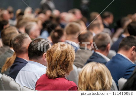 Audience attending a business conference in a professional setting 121410098