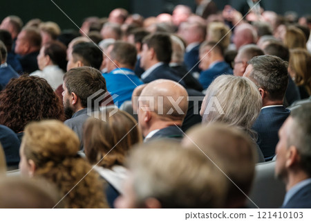 Audience attentively gathered at formal conference presentation or seminar event Audience attentively gathered at formal conference presentation or seminar event 121410103