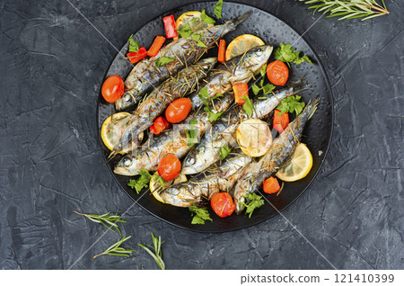 Grilled sardines on a plate with lemon. Grilled sardines on a plate with lemon. 121410399