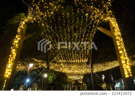 Christmas. Light. Christmas lights through the streets of Vigo. Decorating streets of the city. Fir tree with Christmas lights. Light tree. On. VIGO. SPAIN. 23 December 2024. 121411072