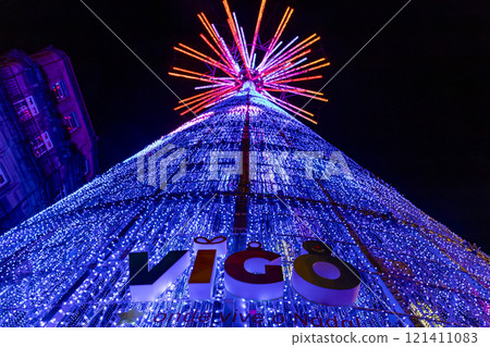 Christmas. Light. Christmas lights through the streets of Vigo. Decorating streets of the city. Fir tree with Christmas lights. Light tree. On. VIGO. SPAIN. 23 December 2024. 121411083