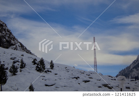 Snowy Mountain Landscape with Communication Tower under Blue Sky Snowy Mountain Landscape with Communication Tower under Blue Sky 121411625