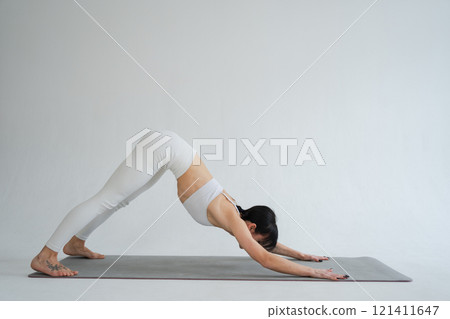 Yoga fitness workout training. Woman practicing yoga isolated on white background. Woman doing sports exercise on yoga mat. Girl in sportswear have training workout for weight loss. Sport and fitness Yoga fitness workout training. Woman practicing yoga isolated on white background. Woman doing sports exercise on yoga mat. Girl in sportswear have training workout for weight loss. Sport and fitness 121411647