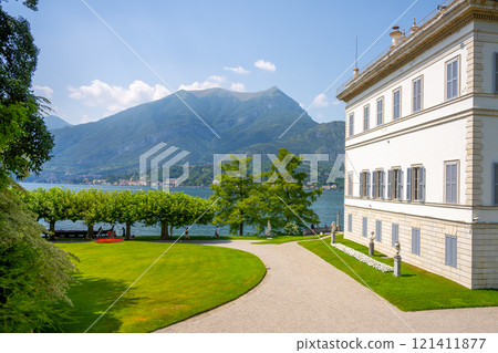 Nestled on the shores of Lake Como, Villa Melzi features lush gardens and stunning views of the surrounding mountains, providing a serene atmosphere for visitors to enjoy the beauty of nature. Nestled on the shores of Lake Como, Villa Melzi features lush gardens and stunning views of the surrounding mountains, providing a serene atmosphere for visitors to enjoy the beauty of nature. 121411877